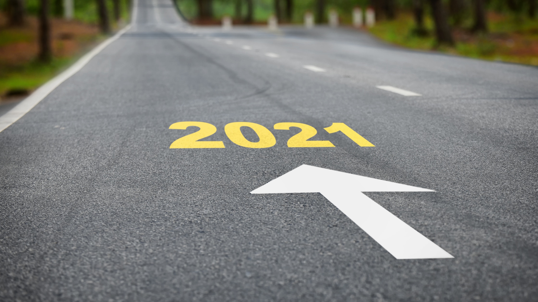 Road marked with 2021 and an arrow, illustrating the year ahead for the workforce