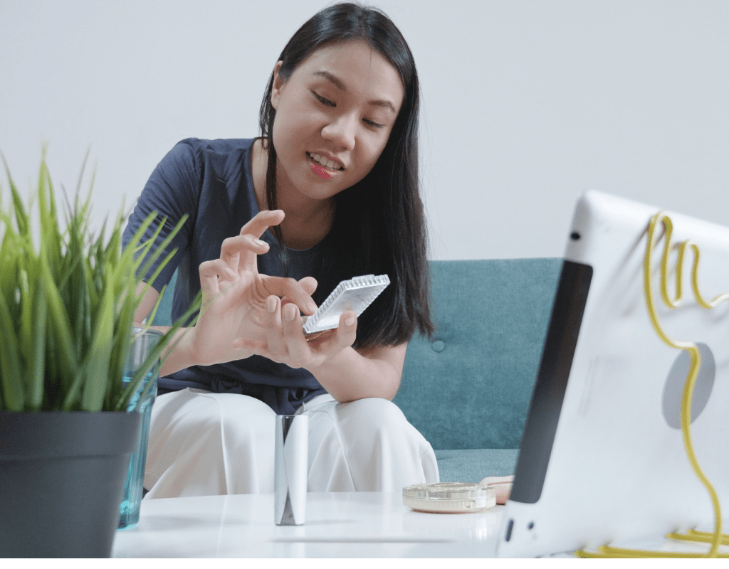 Woman gesturing during a video call at home, illustrating better quality remote conversations