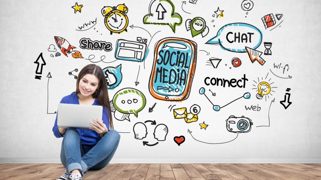 Person with a laptop surrounded by drawn social media icons, illustrating social HR