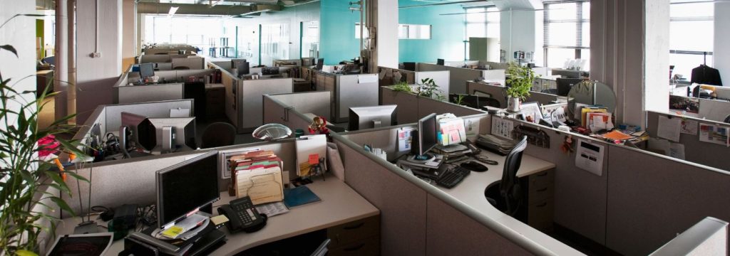 Empty office desks, illustrating the communication gap between HR leaders and employees