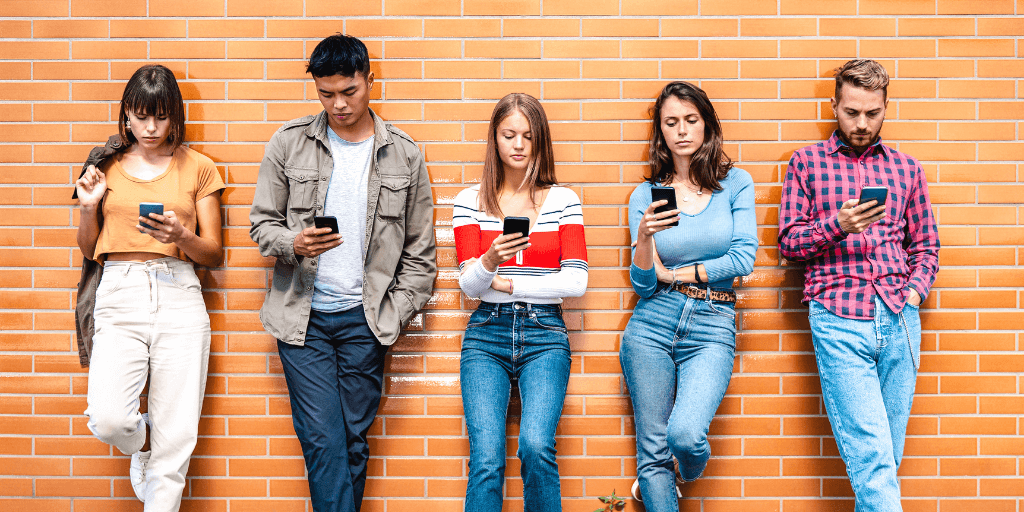 Group of Gen Z employees on their phones