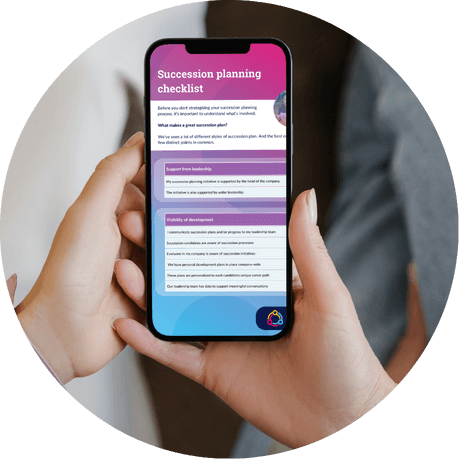 Hands holding a phone showing the succession planning checklist from the guide