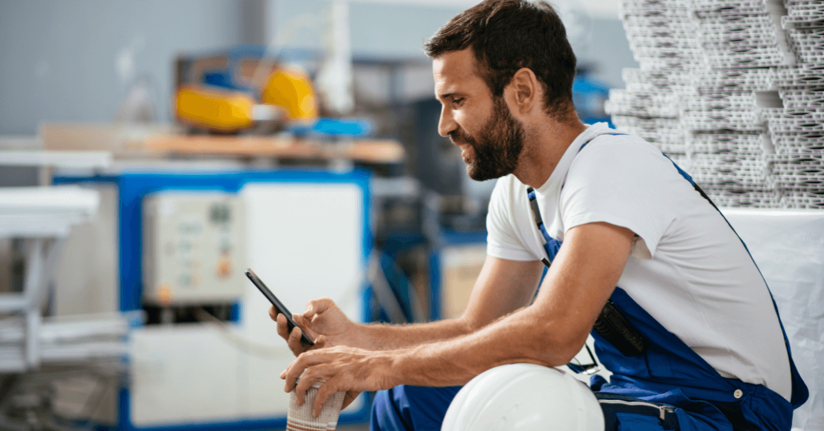 Worker checking their phone on site