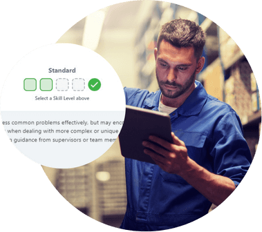 Warehouse worker with a tablet beside a panel rating skill levels