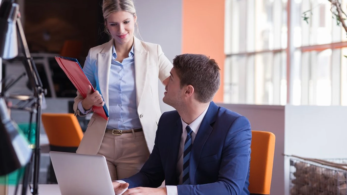 A small team working together around a table in a bright, modern office